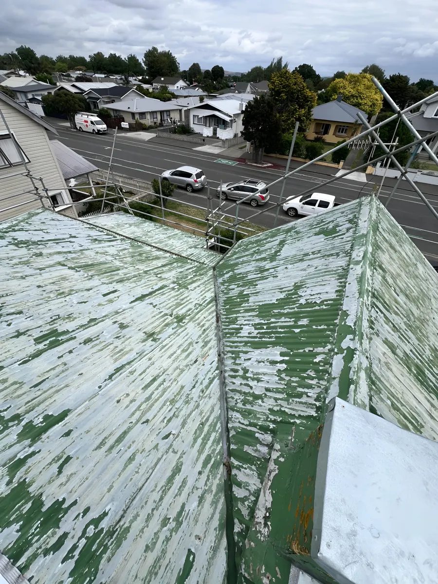 Before roof painting Napier — rusty, faded iron roof